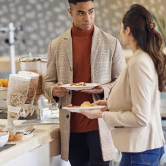 Over shoulder view of kids being served in school cafeteria