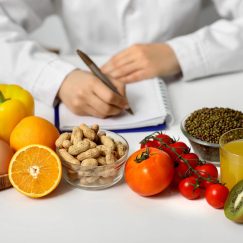 Young,Female,Nutritionist,With,Healthy,Food,Writing,Diet,Plan,In